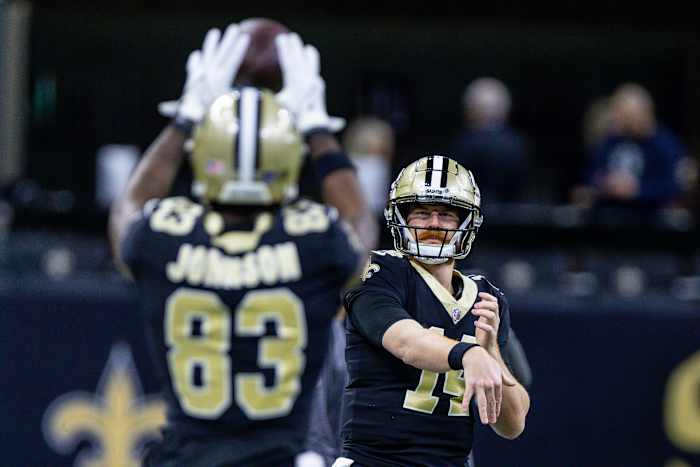 New Orleans Saints quarterback Andy Dalton (14) passes to tight end Juwan Johnson (83) during warm ups